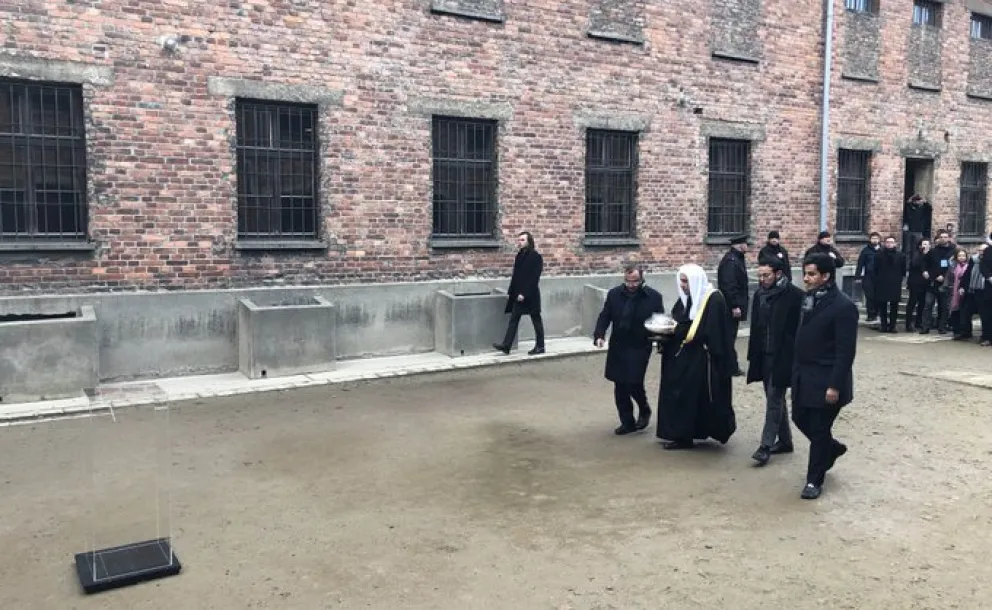 Lors de la visite au Musée d'Auschwitz avec des membres d'AJCGlobal Mohammad Alissa allume une bougie au Mur des Exécutions en mémoire des personnes exécutées.